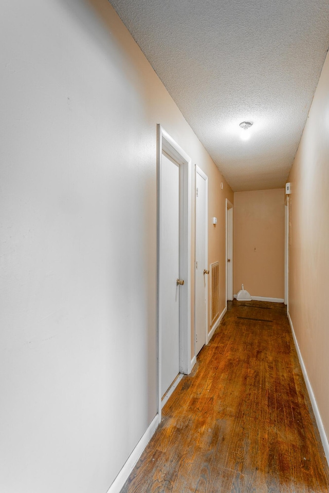 2011 Robbins St, Chattanooga, TN 37404 - hall with a textured ceiling, baseboards, and wood finished floors