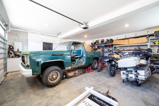 garage with water heater and a garage door opener