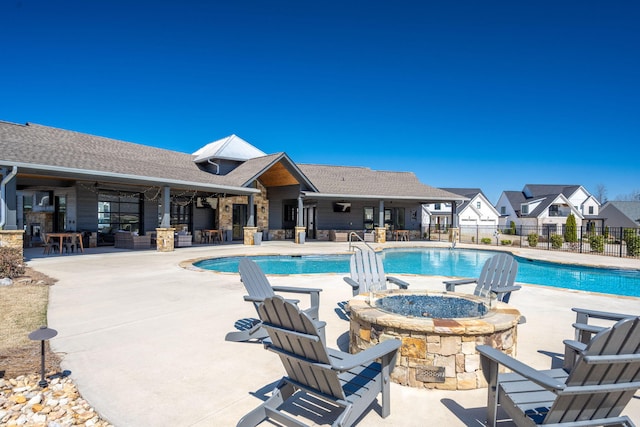 pool featuring a patio, fence, and a fire pit
