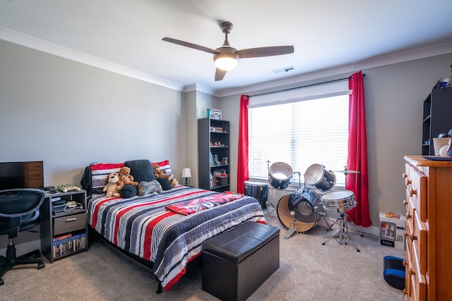 carpeted bedroom featuring visible vents, ceiling fan, and crown molding