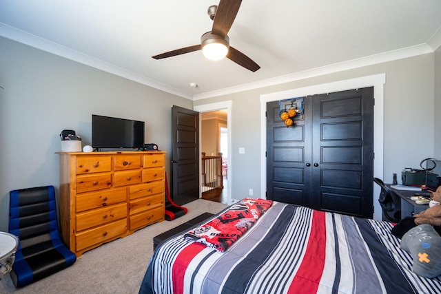 bedroom with ceiling fan, carpet floors, and ornamental molding