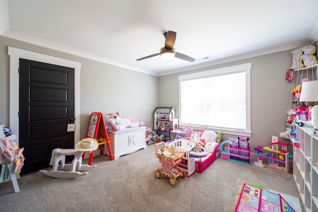 game room with crown molding, carpet flooring, a ceiling fan, and visible vents