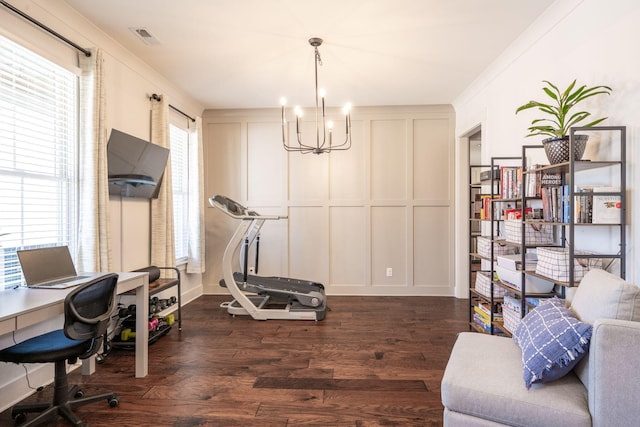 office space featuring a chandelier, a decorative wall, and dark wood finished floors