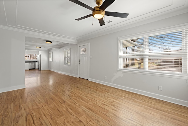 unfurnished living room featuring visible vents, light wood-style flooring, ornamental molding, baseboards, and ceiling fan
