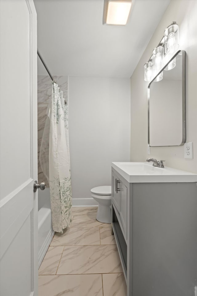 full bathroom with marble finish floor, toilet, vanity, and baseboards