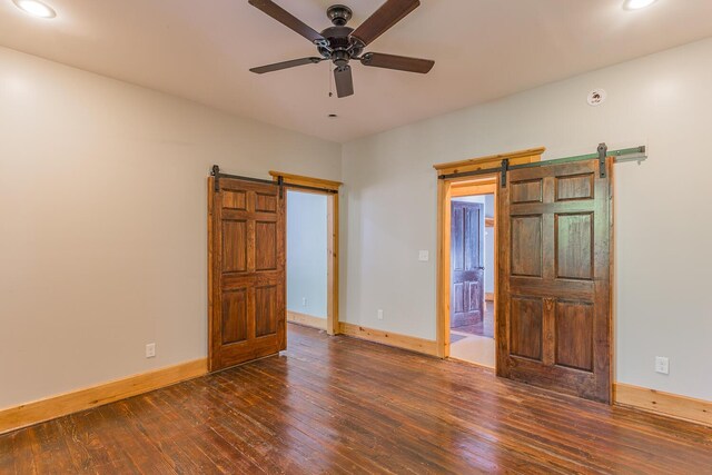 209 Tremont St, Chattanooga, TN 37405 - unfurnished bedroom featuring recessed lighting, baseboards, a barn door, and wood-type flooring