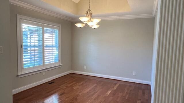 unfurnished room with a chandelier, ornamental molding, baseboards, and dark wood-type flooring