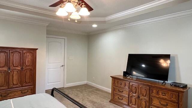 bedroom featuring crown molding, ceiling fan, carpet flooring, a raised ceiling, and baseboards