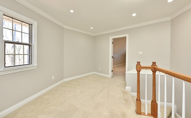 spare room with light carpet, baseboards, ornamental molding, and recessed lighting
