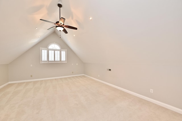 bonus room with baseboards, a ceiling fan, vaulted ceiling, and light carpet