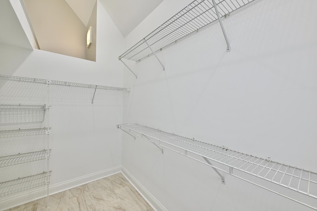 spacious closet with marble finish floor