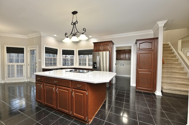 kitchen featuring stainless steel fridge with ice dispenser, a kitchen island, light countertops, dark tile patterned floors, and black electric cooktop