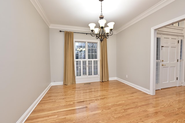 unfurnished dining area with a chandelier, light wood-style floors, baseboards, and crown molding