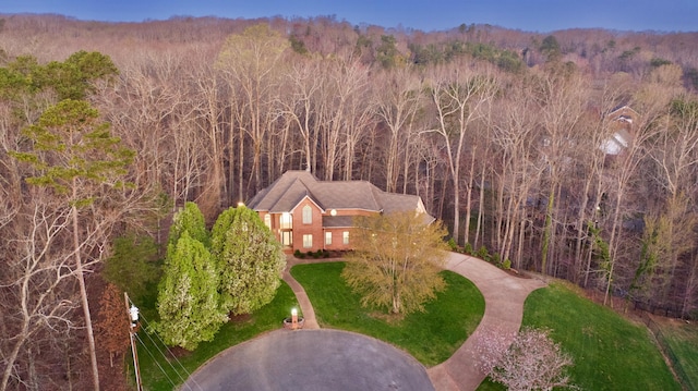 birds eye view of property with a view of trees