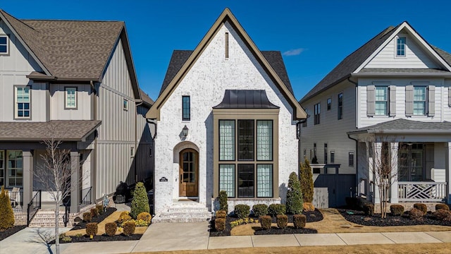 view of front of house featuring board and batten siding and a shingled roof