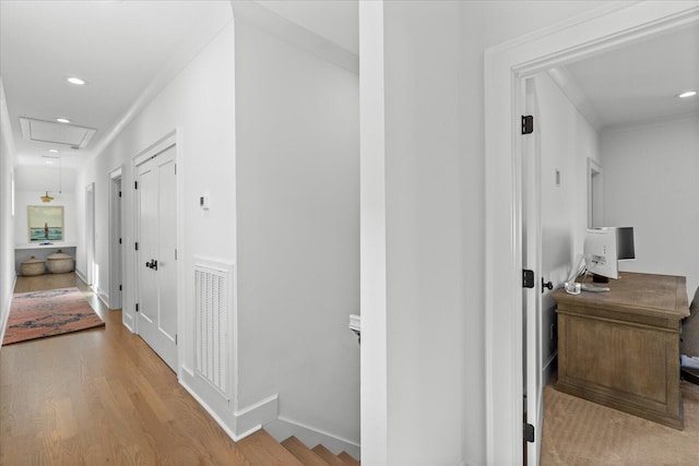 hallway featuring visible vents, recessed lighting, wood finished floors, attic access, and baseboards