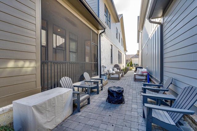 view of patio / terrace featuring a sunroom