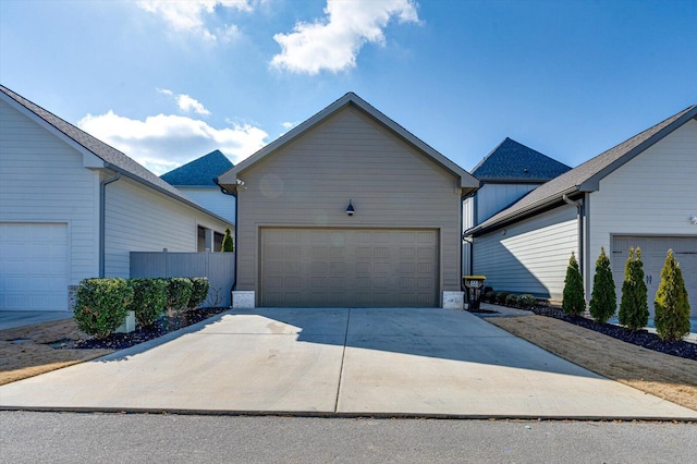ranch-style house with an outdoor structure, a garage, and concrete driveway