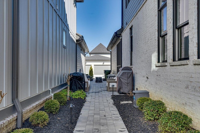 view of patio / terrace featuring an outbuilding and a grill