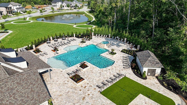 pool featuring a patio area and a water view