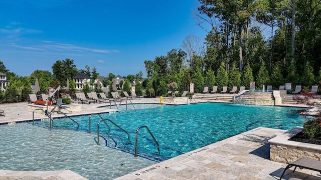 pool featuring a patio and fence