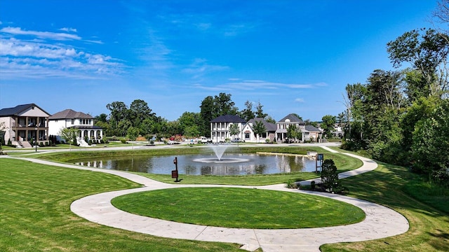 view of home's community featuring a water view and a lawn