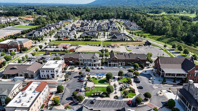 birds eye view of property featuring a forest view and a residential view