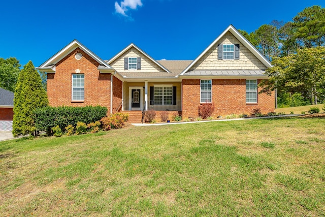 view of front of house featuring a front lawn and brick siding