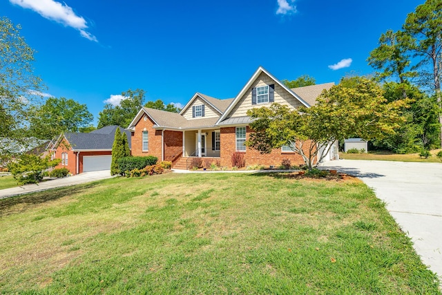view of front of property featuring brick siding, driveway, an attached garage, and a front yard