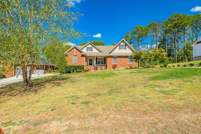 view of front of home with a front yard, brick siding, and driveway