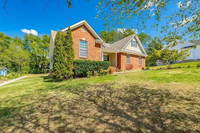 view of front facade featuring brick siding and a front lawn