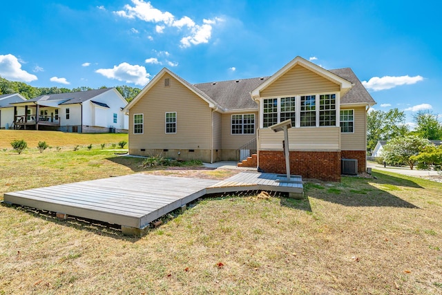 back of house featuring crawl space, a lawn, a wooden deck, and central AC