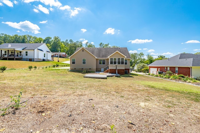 back of house with crawl space, a garage, and a yard