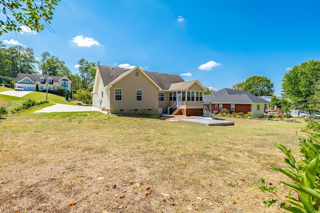 back of house featuring a yard, driveway, and crawl space