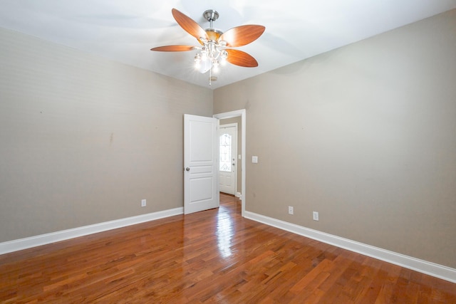 spare room featuring light wood-style flooring, baseboards, and ceiling fan