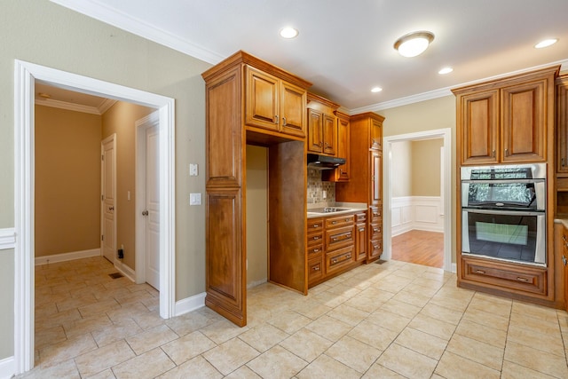 kitchen featuring brown cabinets, ornamental molding, under cabinet range hood, stainless steel double oven, and recessed lighting
