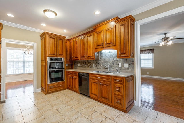kitchen featuring brown cabinetry, a sink, light countertops, black dishwasher, and double oven