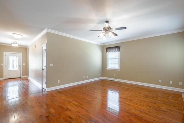empty room with ornamental molding, baseboards, a ceiling fan, and hardwood / wood-style floors
