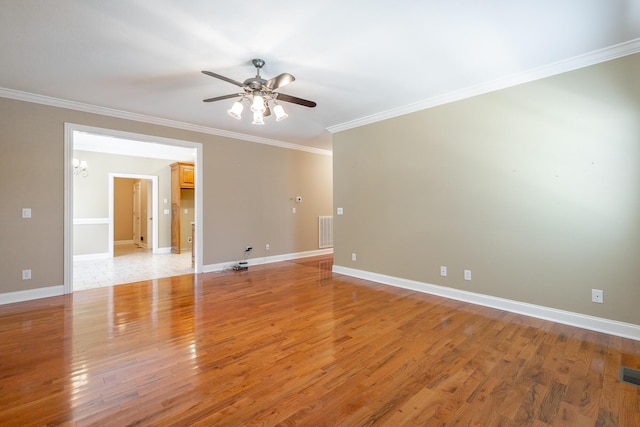 spare room featuring visible vents, ceiling fan with notable chandelier, crown molding, and light wood-type flooring