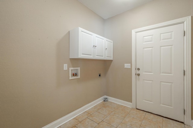 clothes washing area with hookup for a washing machine, light tile patterned floors, baseboards, hookup for an electric dryer, and cabinet space