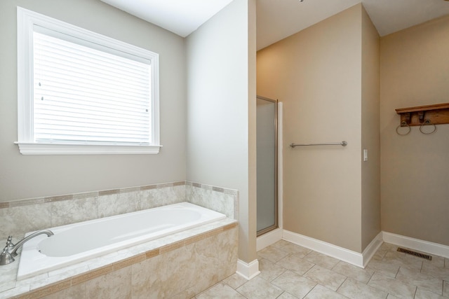 bathroom featuring visible vents, a shower stall, tile patterned flooring, baseboards, and a bath