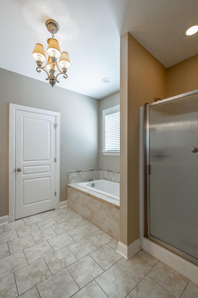 full bath with tile patterned floors, a notable chandelier, a stall shower, baseboards, and a bath