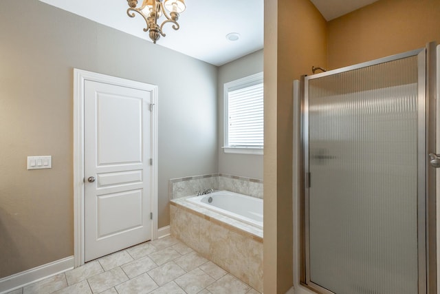 bathroom with a bath, a notable chandelier, a shower stall, and tile patterned floors