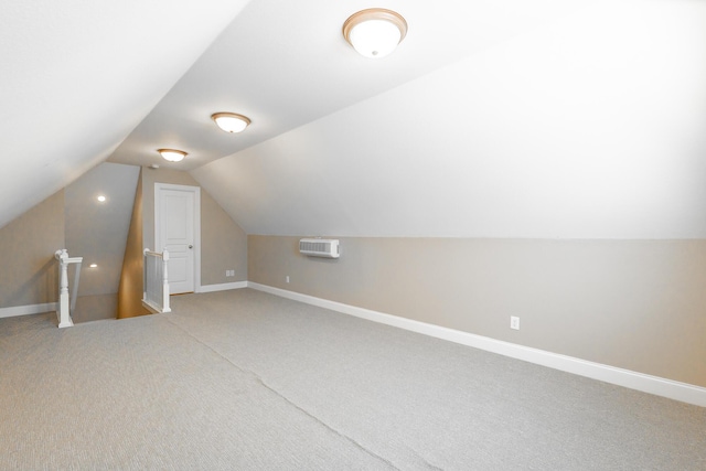 bonus room featuring lofted ceiling, light colored carpet, and baseboards