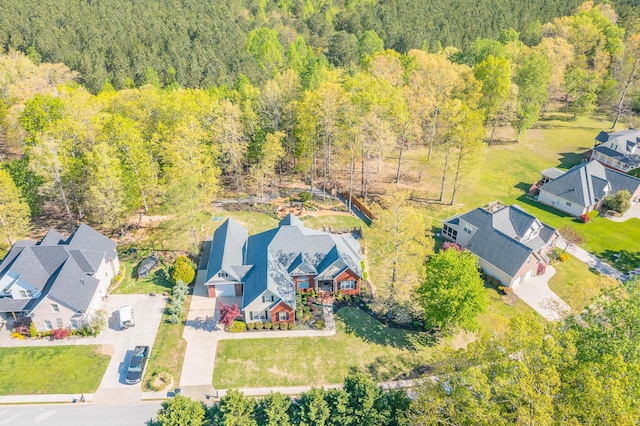 drone / aerial view featuring a residential view and a forest view