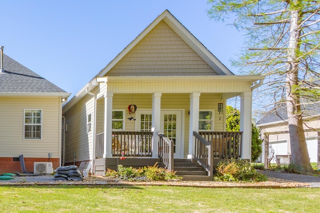 view of front of property with a porch and a front lawn