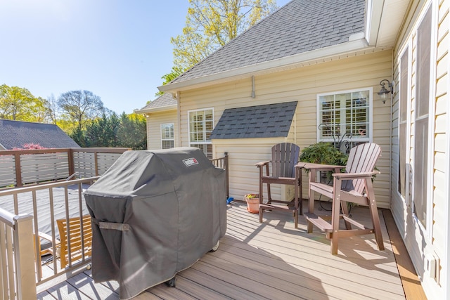 wooden deck with a grill