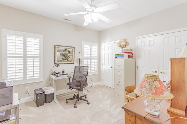 office with a ceiling fan, light colored carpet, and plenty of natural light