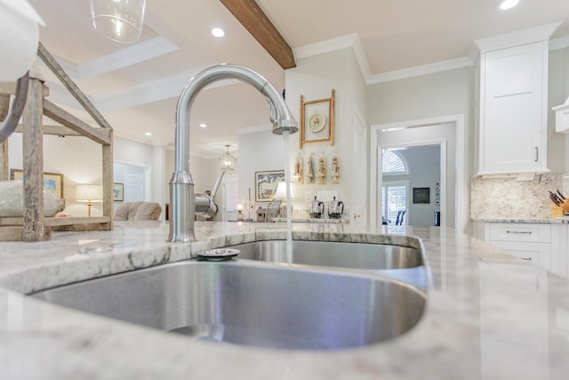 room details featuring crown molding, light stone countertops, recessed lighting, white cabinets, and a sink
