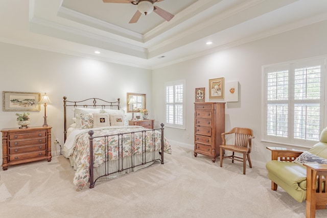 carpeted bedroom with ceiling fan, a raised ceiling, recessed lighting, baseboards, and ornamental molding